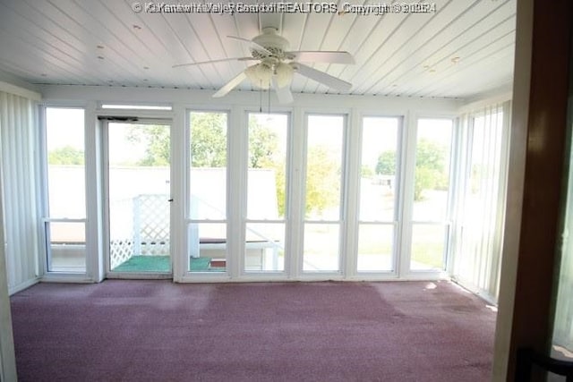 unfurnished sunroom featuring wooden ceiling and ceiling fan