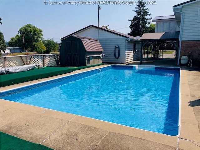 view of swimming pool with fence and an outdoor structure