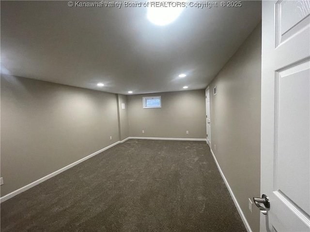 basement featuring recessed lighting, dark carpet, and baseboards