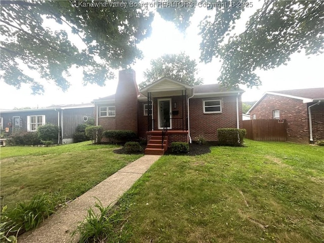 bungalow-style house with a chimney, fence, a front lawn, and brick siding