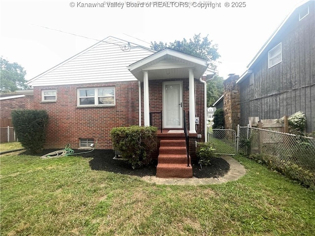 bungalow-style home with entry steps, a gate, fence, a front lawn, and brick siding