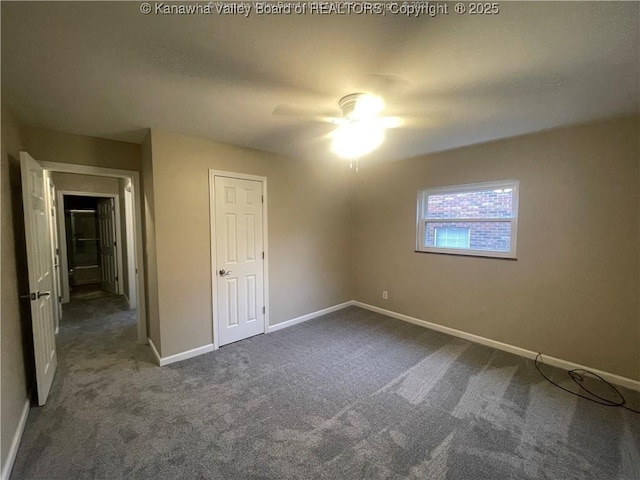 unfurnished bedroom featuring ceiling fan, baseboards, and dark carpet