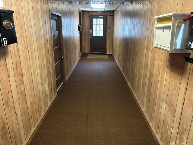 hall featuring wooden walls