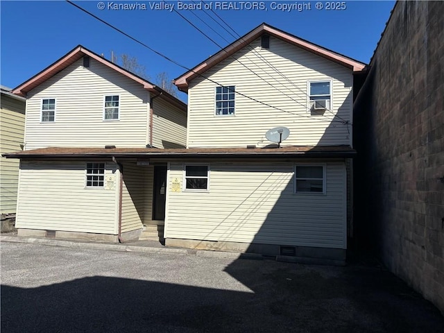 back of property with entry steps, crawl space, and cooling unit