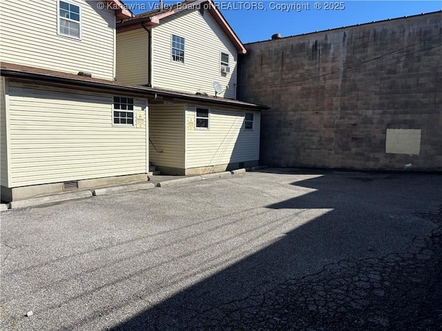 back of house featuring crawl space