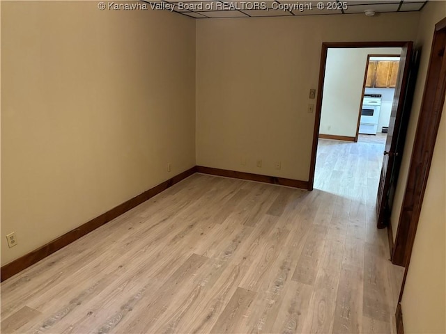 empty room with light wood finished floors and baseboards