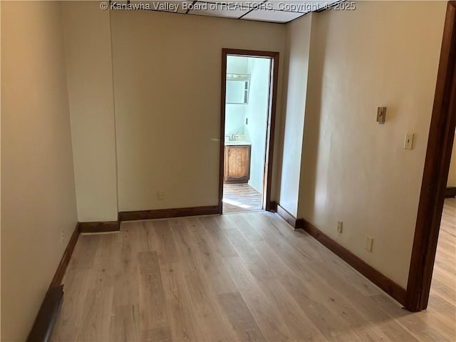 empty room featuring light wood-style flooring and baseboards