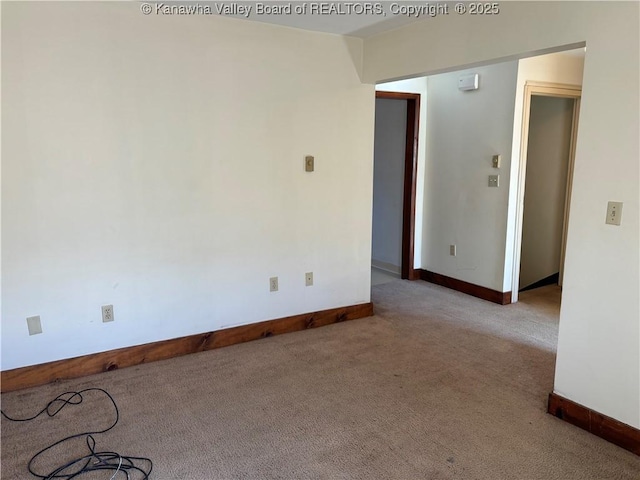 empty room with light carpet and baseboards