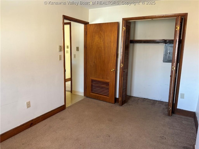 unfurnished bedroom featuring carpet floors, a closet, and baseboards