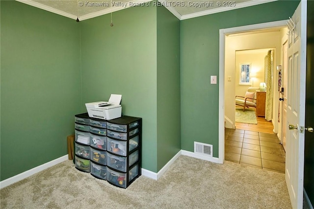 interior space with ornamental molding, visible vents, and baseboards