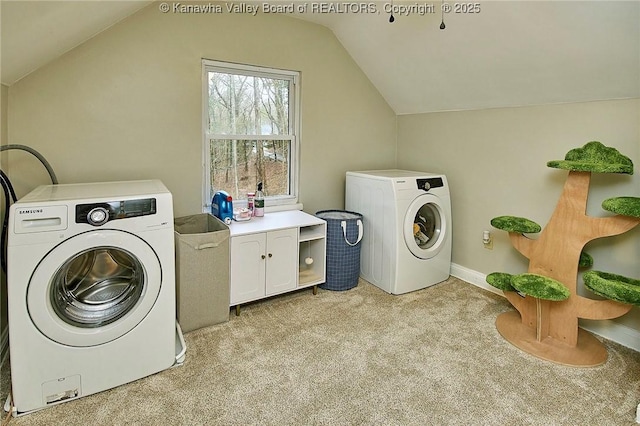 laundry room with baseboards, light colored carpet, cabinet space, and washer and dryer