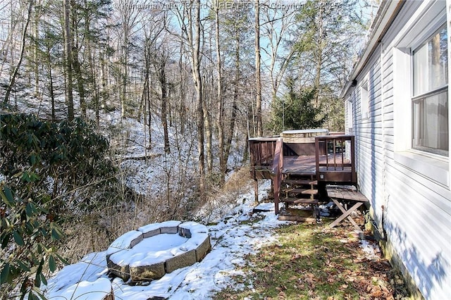 yard layered in snow with a wooden deck