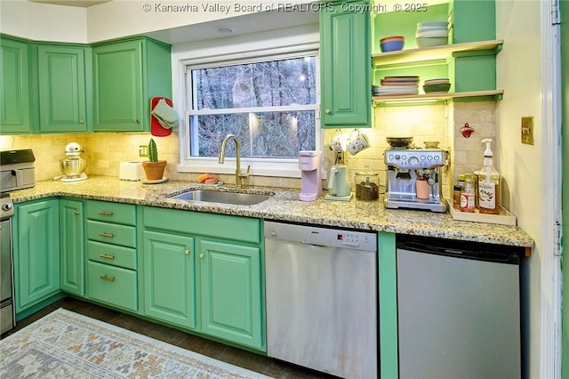 kitchen featuring refrigerator, a sink, backsplash, light stone countertops, and dishwasher