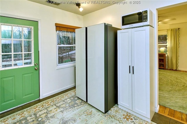 kitchen featuring white appliances and baseboards