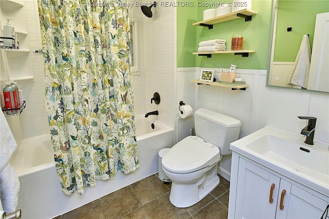 bathroom featuring toilet, vanity, shower / bath combination with curtain, and wainscoting