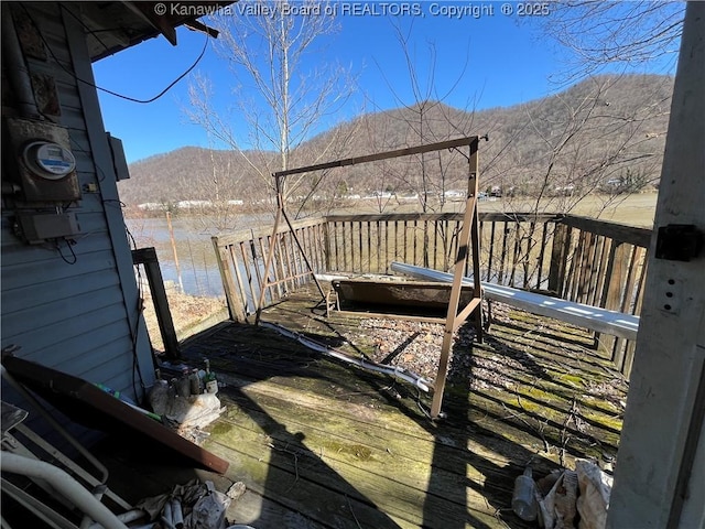 wooden deck with a mountain view