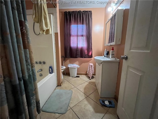 full bathroom featuring toilet, shower / bath combo with shower curtain, tile patterned flooring, and vanity