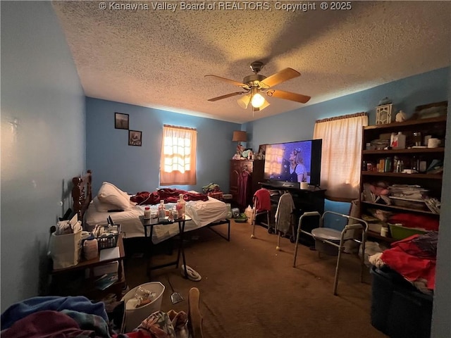 bedroom featuring carpet floors, a ceiling fan, and a textured ceiling