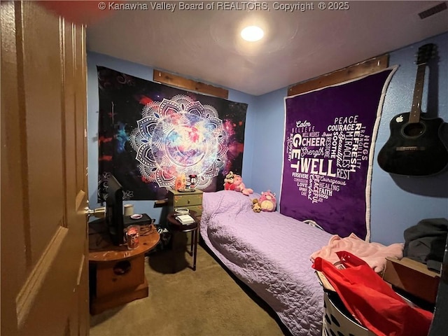 carpeted bedroom featuring visible vents