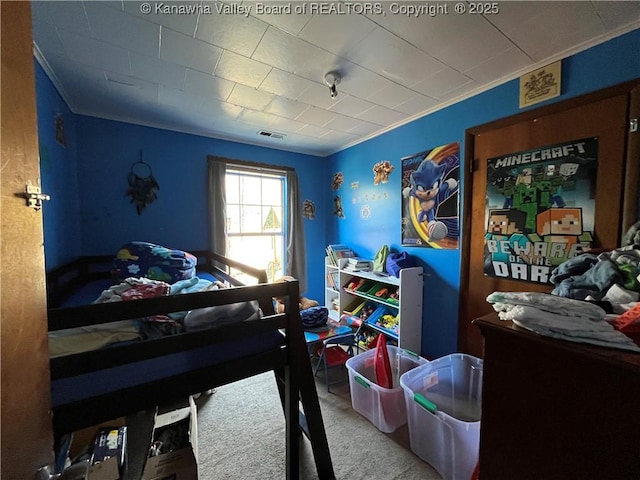 bedroom with ornamental molding, visible vents, and carpet flooring