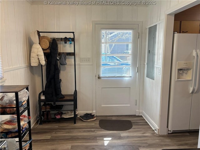 doorway to outside featuring electric panel and wood finished floors