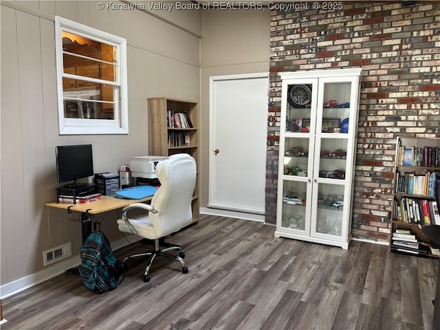 office featuring visible vents and wood finished floors