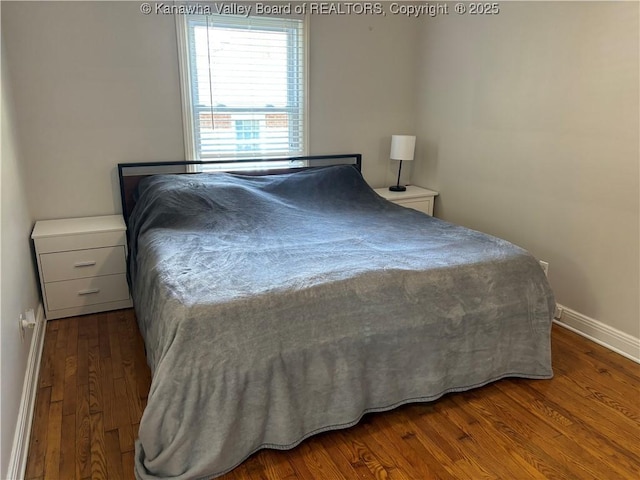 bedroom featuring baseboards and wood finished floors