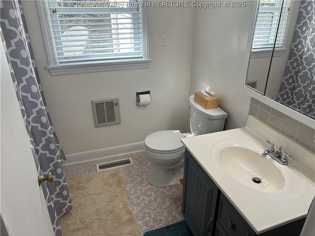 bathroom with toilet, baseboards, visible vents, and vanity