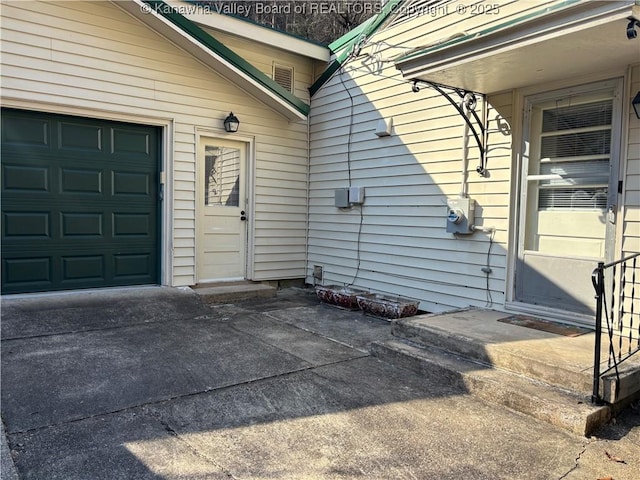 view of side of home with a garage and driveway