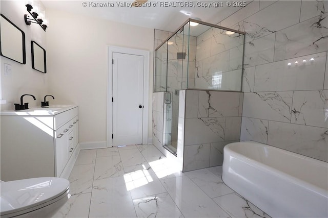 full bath featuring marble finish floor, a garden tub, a shower stall, and vanity