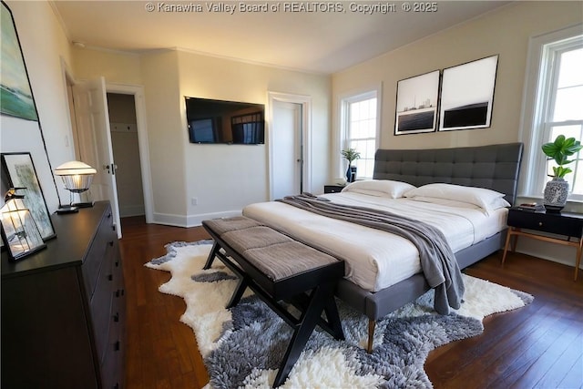 bedroom featuring crown molding, baseboards, and dark wood-style flooring