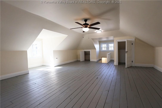 bonus room with ceiling fan, wood-type flooring, baseboards, and vaulted ceiling