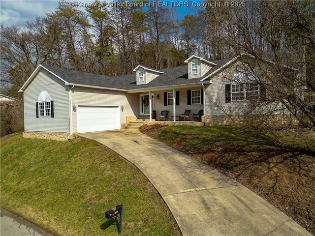 cape cod-style house with a porch, a garage, driveway, roof with shingles, and a front yard