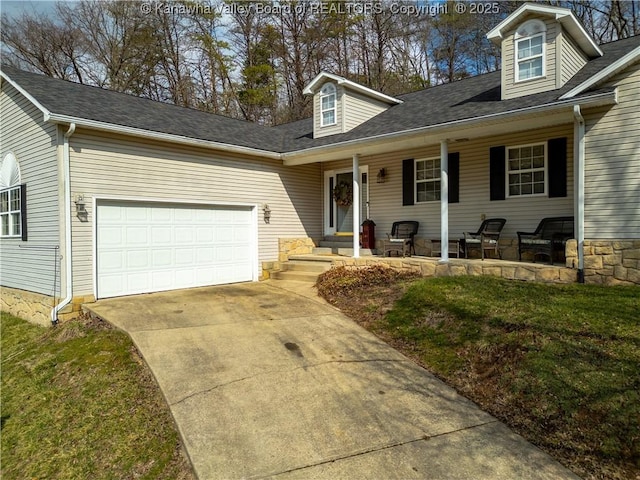 cape cod-style house featuring covered porch, driveway, and an attached garage