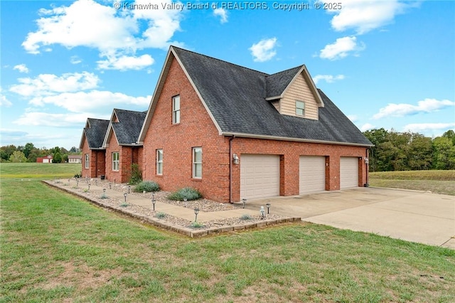 view of side of home with a yard, driveway, brick siding, and roof with shingles