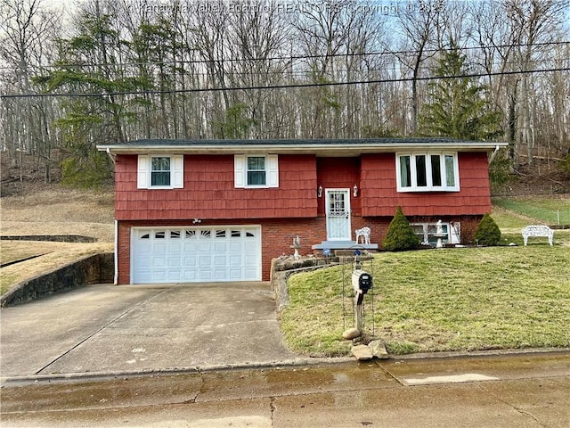 split foyer home with concrete driveway, brick siding, an attached garage, and a front yard