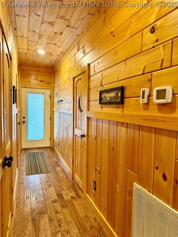 2299 Striker Fork Rd, Chapmanville, WV 25508 - corridor with visible vents, wooden ceiling, wood walls, and hardwood / wood-style floors