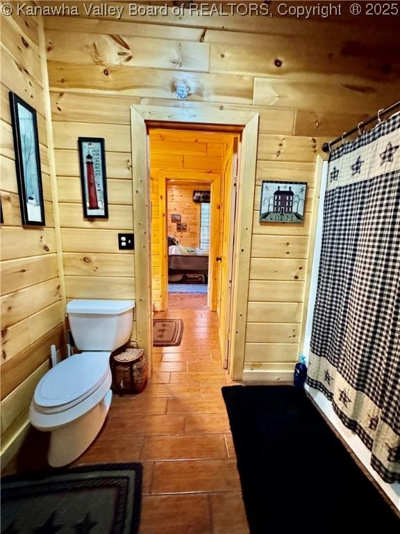 2299 Striker Fork Rd, Chapmanville, WV 25508 - bathroom featuring toilet and wooden walls