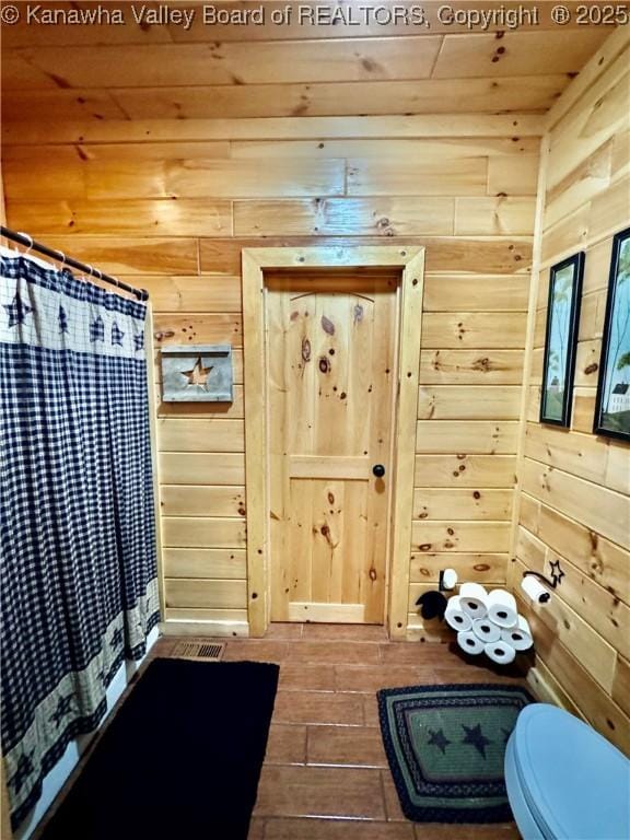 2299 Striker Fork Rd, Chapmanville, WV 25508 - full bath featuring a shower with shower curtain, wooden ceiling, wooden walls, toilet, and wood finished floors