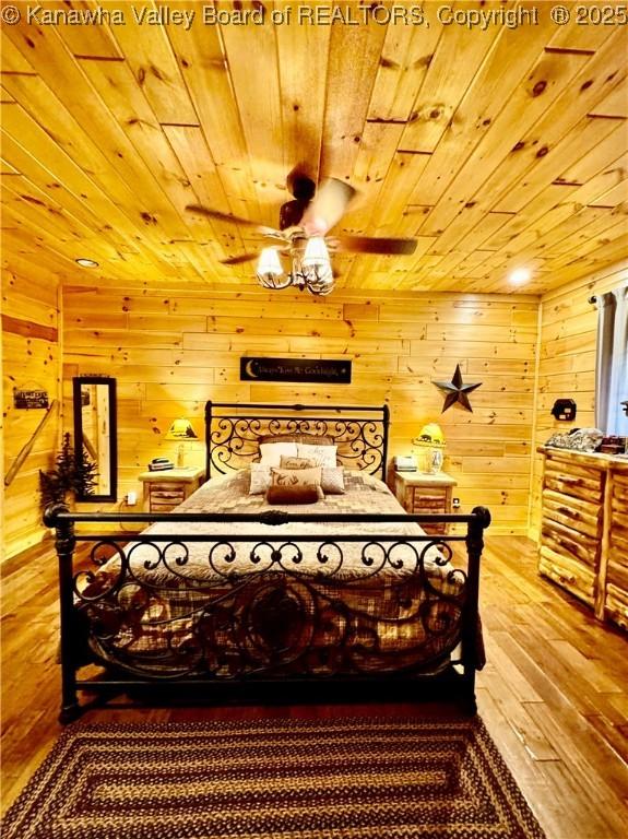 2299 Striker Fork Rd, Chapmanville, WV 25508 - bedroom with hardwood / wood-style floors, wood walls, and wood ceiling