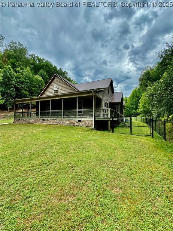 2299 Striker Fork Rd, Chapmanville, WV 25508 - back of property featuring metal roof, a yard, and fence