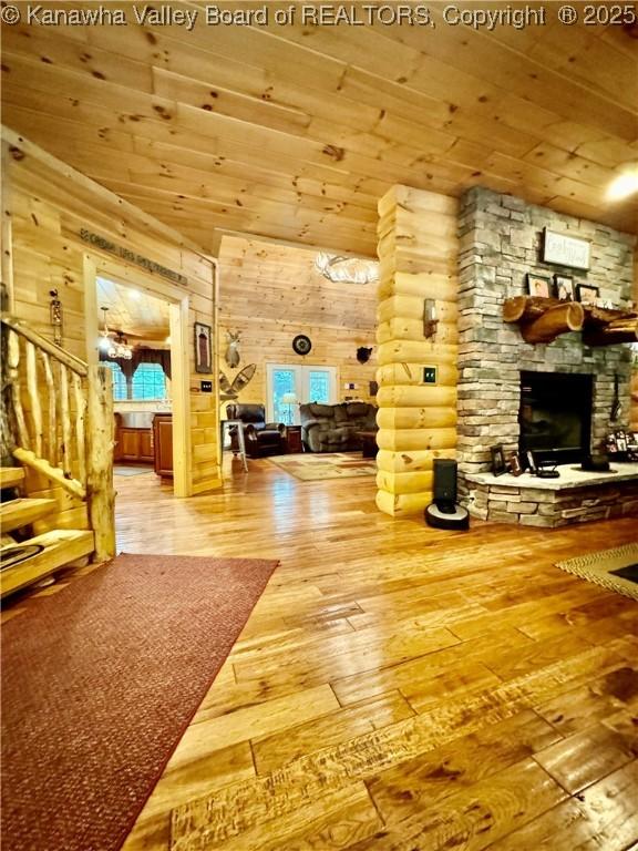 2299 Striker Fork Rd, Chapmanville, WV 25508 - interior space with wood-type flooring, a stone fireplace, wooden ceiling, and stairway