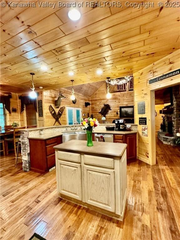 2299 Striker Fork Rd, Chapmanville, WV 25508 - kitchen featuring a center island, wooden walls, and light wood-style flooring