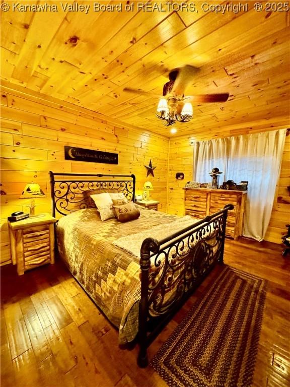 2299 Striker Fork Rd, Chapmanville, WV 25508 - bedroom with wooden walls, hardwood / wood-style flooring, ceiling fan with notable chandelier, and wooden ceiling