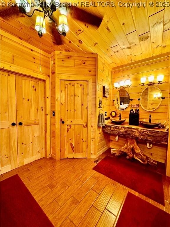 2299 Striker Fork Rd, Chapmanville, WV 25508 - bathroom with wood walls, wood finished floors, an inviting chandelier, and wooden ceiling