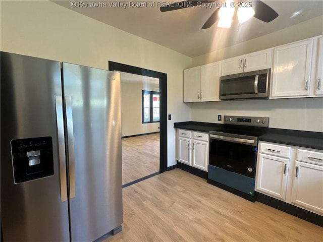 kitchen featuring stainless steel appliances and white cabinetry