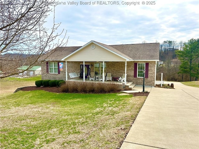 ranch-style home with a front yard and brick siding