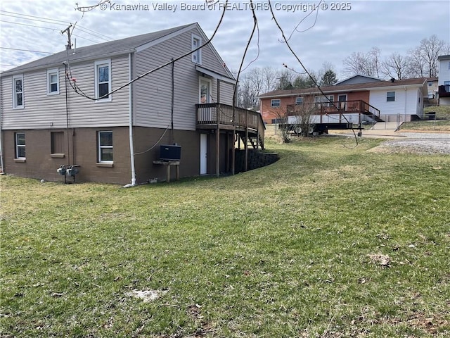 view of home's exterior with a wooden deck, stairway, and a yard