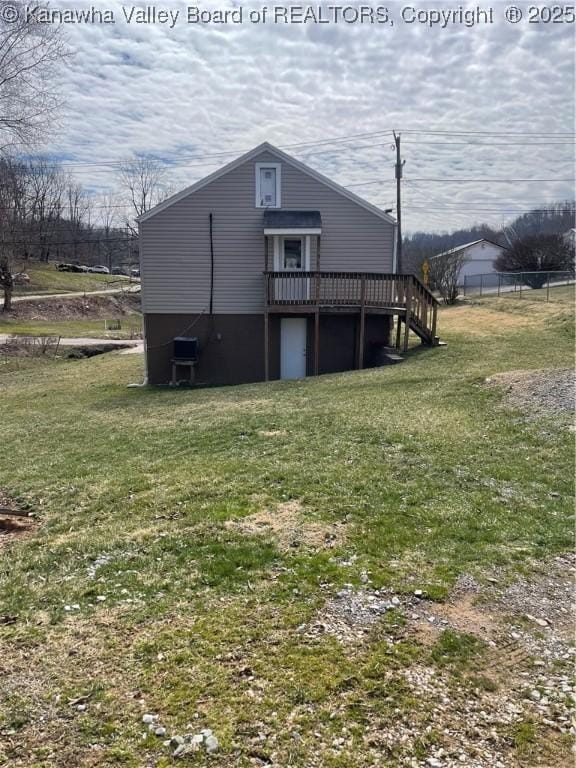 view of property exterior with a lawn and a wooden deck