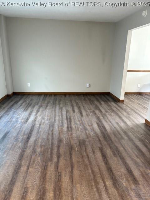 empty room with baseboards and wood finished floors